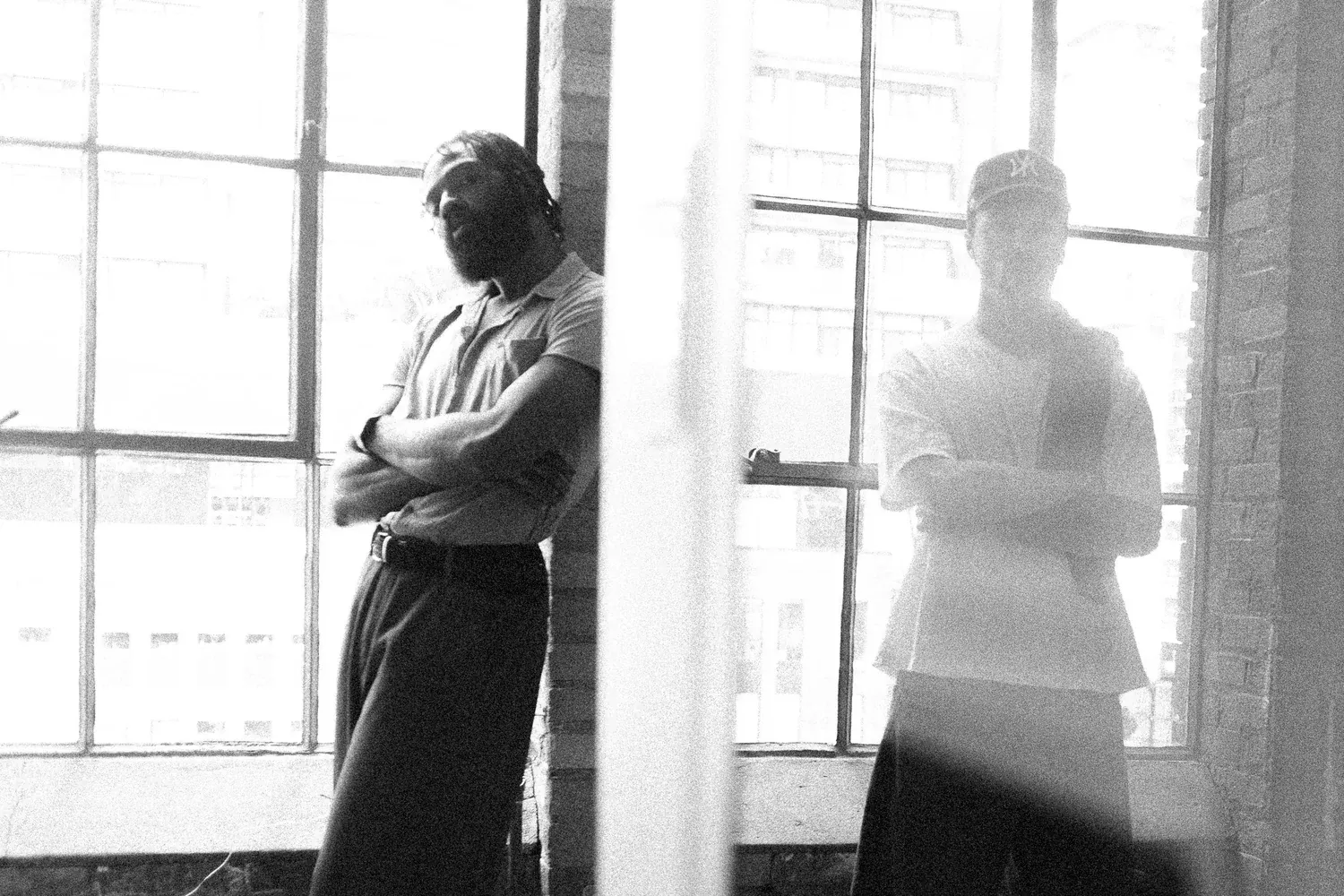 Black-and-white photo of Garçons by a window